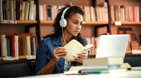 woman studying and looking at a computer